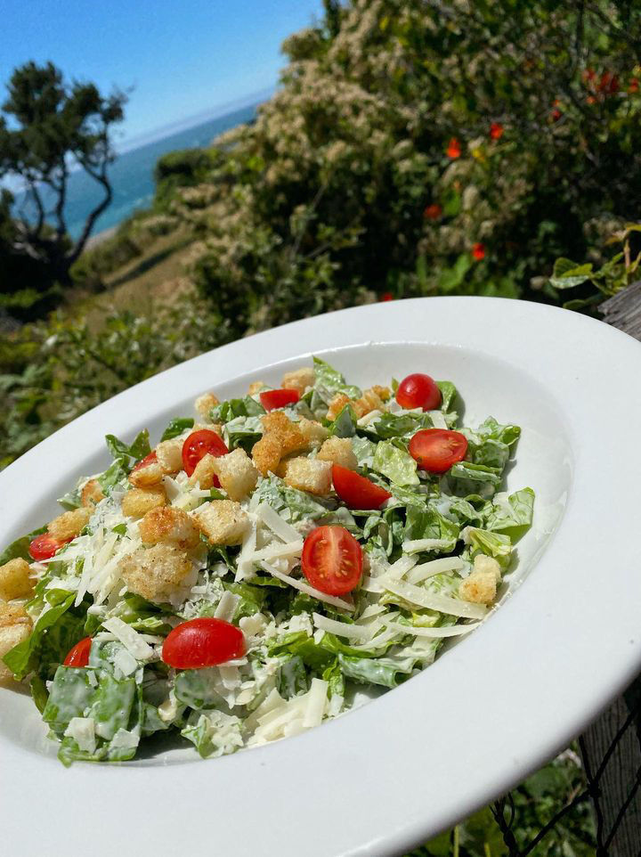Caesar salad with the ocean behind